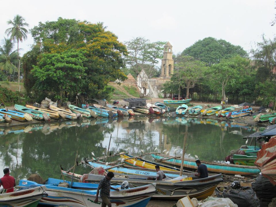 Negombo Lagoon at sunset with fishing boats on the water, Sri Lanka